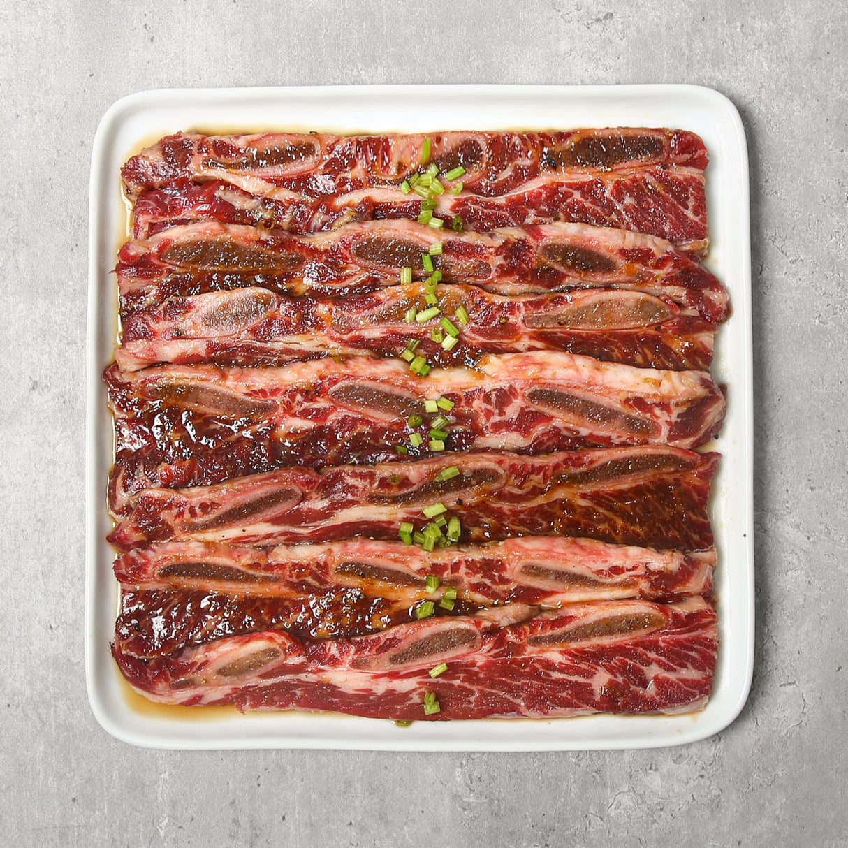 Beef short ribs are expertly cut across the rib bones and marinated in our signature sauce, perfect for grilling or pan-frying