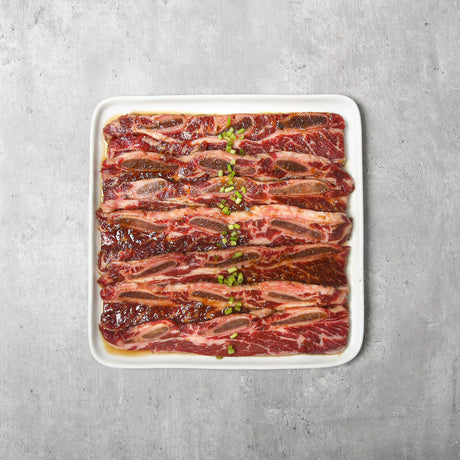 Beef short ribs are expertly cut across the rib bones and marinated in our signature sauce, perfect for grilling or pan-frying