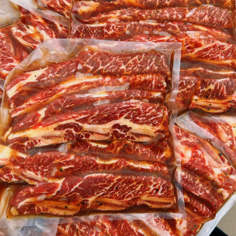 Beef short ribs are expertly cut across the rib bones and marinated in our signature sauce, perfect for grilling or pan-frying