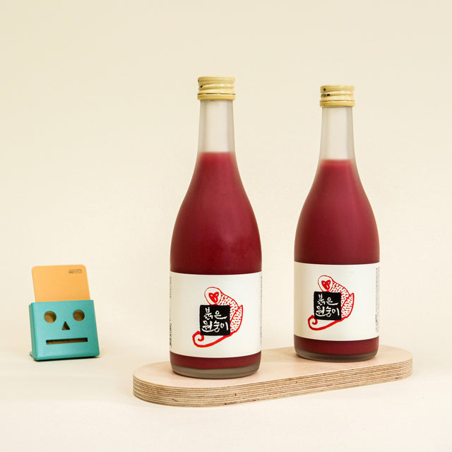 Sulseam Red Monkey Makgeolli, crafted in 2016, with a natural red hue from red yeast fermentation, offering a delicate sweetness and clean taste, ideal with light snacks