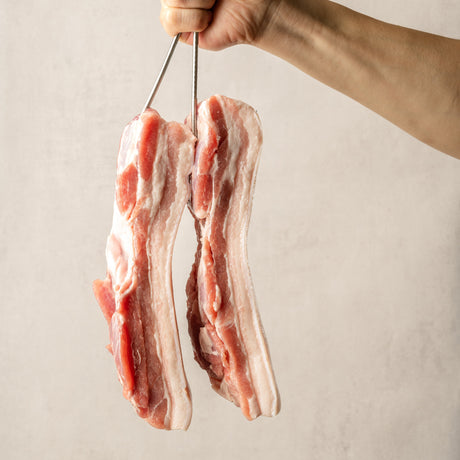 Whole premium Spanish chestnut-fed Duroc pork belly with rich marbling, perfect for making bossam